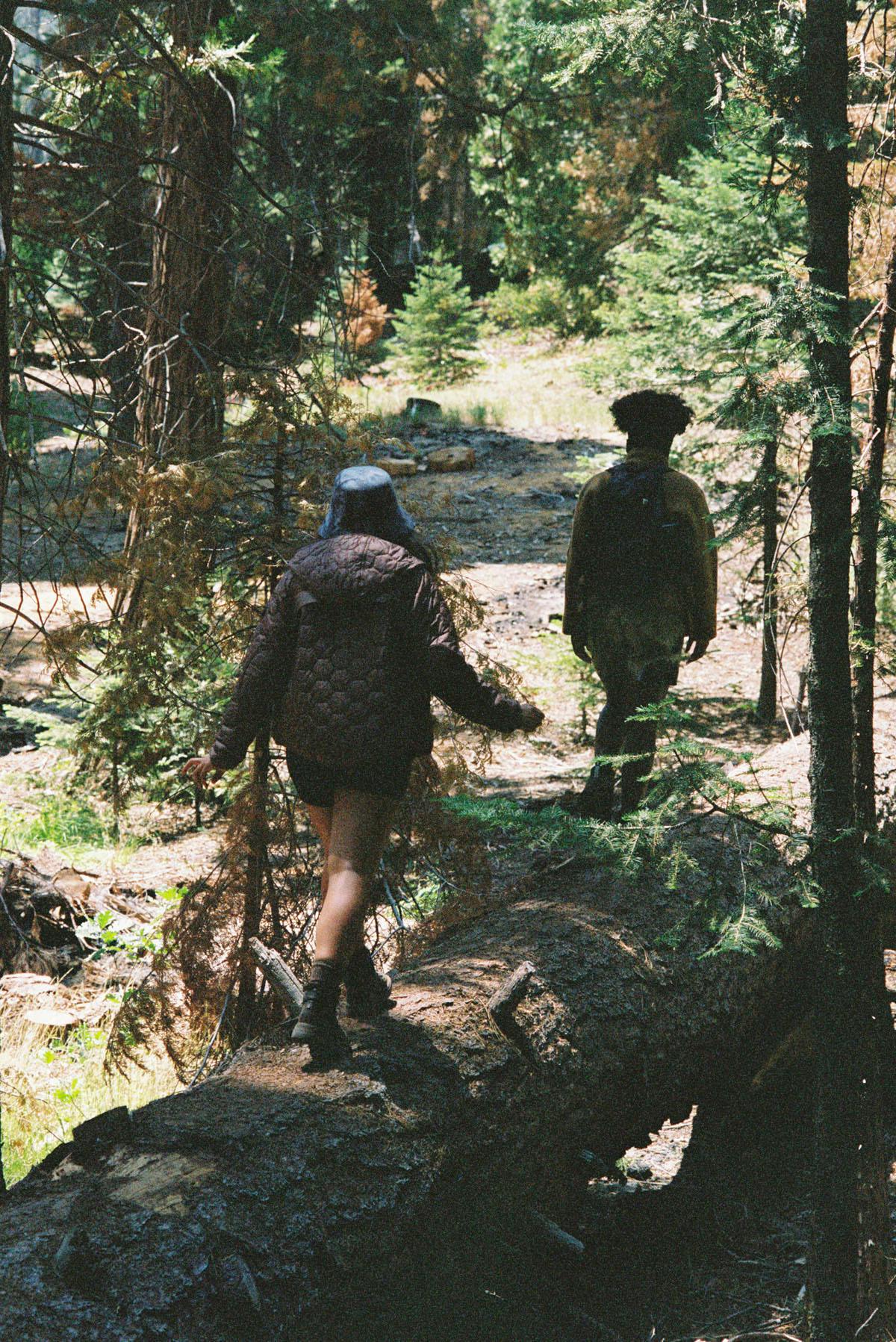NOODLES and Alyssa Gilbert walking in the forest for Woolrich × Highsnobiety